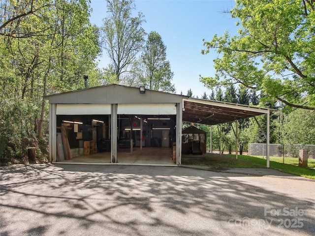 garage featuring a garage and fence