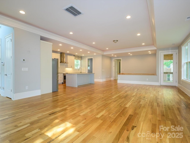 7324 Leharne Dr, Charlotte, NC 28270 - unfurnished living room with baseboards, ornamental molding, light wood-type flooring, and visible vents