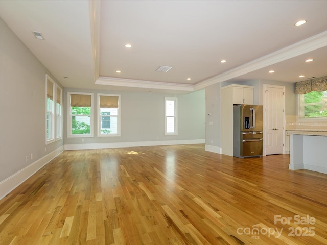 7324 Leharne Dr, Charlotte, NC 28270 - unfurnished living room featuring visible vents, crown molding, a tray ceiling, recessed lighting, and light wood-style flooring