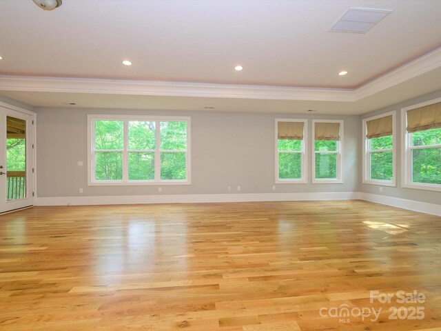 7324 Leharne Dr, Charlotte, NC 28270 - spare room featuring crown molding, baseboards, light wood-style flooring, and a healthy amount of sunlight