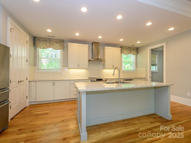 7324 Leharne Dr, Charlotte, NC 28270 - kitchen with white cabinets, a healthy amount of sunlight, a sink, and wall chimney exhaust hood