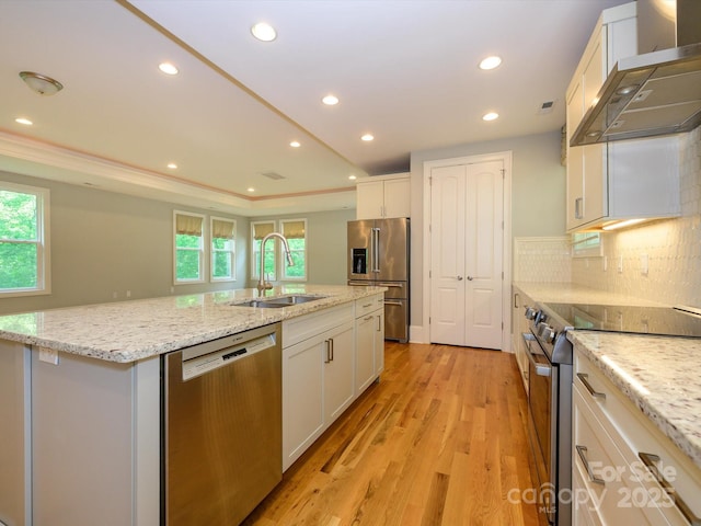 7324 Leharne Dr, Charlotte, NC 28270 - kitchen with wall chimney range hood, a sink, stainless steel appliances, a healthy amount of sunlight, and a center island with sink