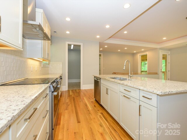 7324 Leharne Dr, Charlotte, NC 28270 - kitchen with wall chimney range hood, appliances with stainless steel finishes, a sink, an island with sink, and decorative backsplash