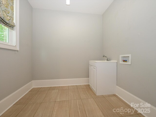 7324 Leharne Dr, Charlotte, NC 28270 - laundry room with a sink, washer hookup, baseboards, and cabinet space