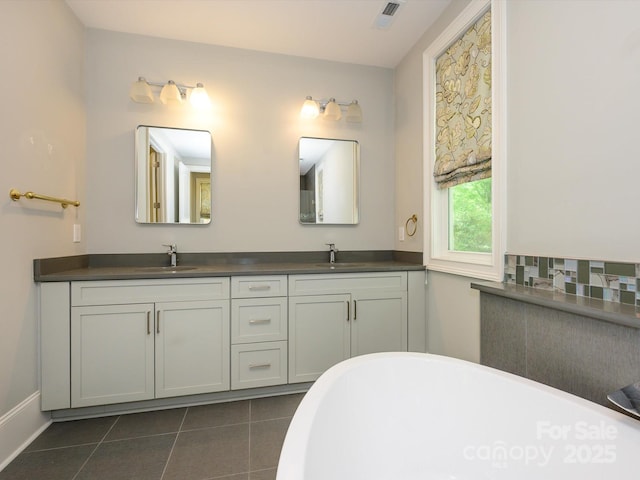 7324 Leharne Dr, Charlotte, NC 28270 - full bath featuring double vanity, tile patterned floors, a freestanding bath, and a sink