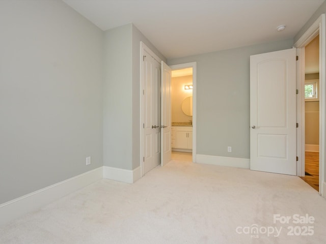 7324 Leharne Dr, Charlotte, NC 28270 - unfurnished bedroom with connected bathroom, baseboards, and light carpet