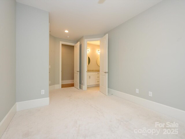 7324 Leharne Dr, Charlotte, NC 28270 - unfurnished bedroom featuring baseboards, recessed lighting, connected bathroom, and light colored carpet