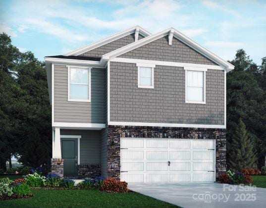 view of front of home with driveway, stone siding, and a garage