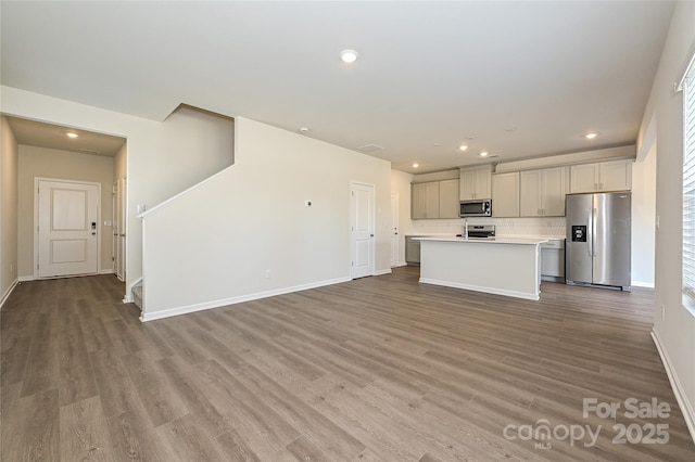 kitchen with recessed lighting, light countertops, tasteful backsplash, and stainless steel appliances