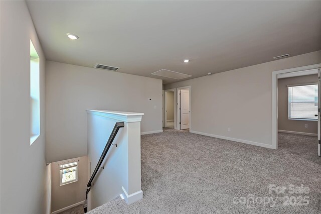 1350 31st St, Conover, NC 28613 - unfurnished room featuring visible vents, attic access, carpet flooring, and a wealth of natural light