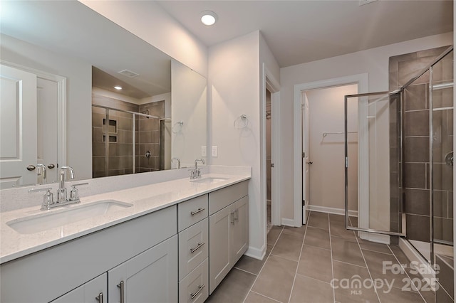full bathroom featuring a sink, tile patterned floors, a stall shower, and visible vents