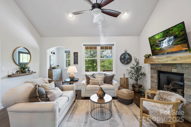 9 Oak Mountain Dr, Leicester, NC 28748 - living room with ceiling fan, wood finished floors, a fireplace, arched walkways, and high vaulted ceiling