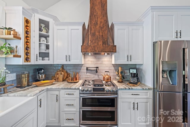9 Oak Mountain Dr, Leicester, NC 28748 - kitchen with stainless steel appliances, custom exhaust hood, white cabinets, glass insert cabinets, and backsplash