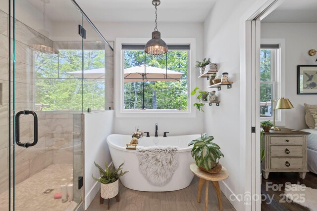 9 Oak Mountain Dr, Leicester, NC 28748 - full bathroom with a freestanding tub, plenty of natural light, a stall shower, and wood finished floors