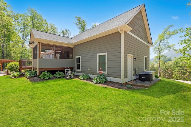 9 Oak Mountain Dr, Leicester, NC 28748 - rear view of property featuring a sunroom, a lawn, and roof with shingles