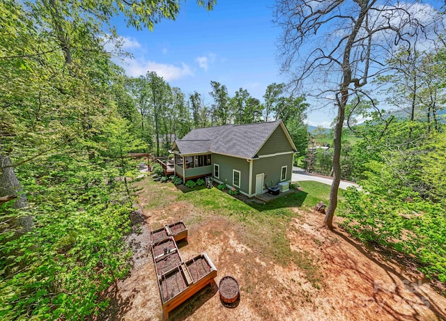 9 Oak Mountain Dr, Leicester, NC 28748 - view of side of home featuring a deck, roof with shingles, dirt driveway, and central AC