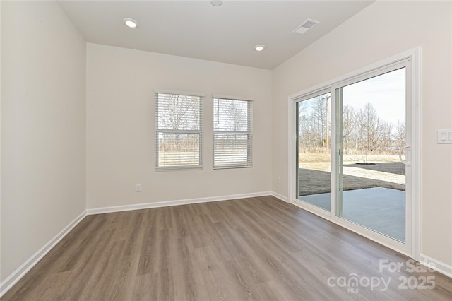 unfurnished room featuring recessed lighting, baseboards, visible vents, and wood finished floors