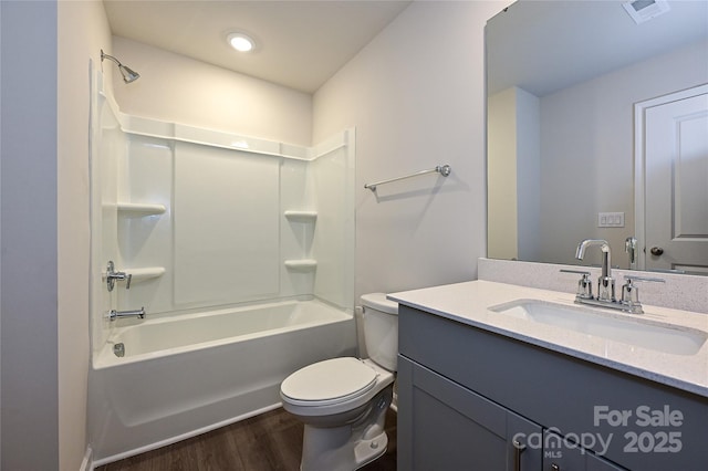 bathroom featuring vanity, toilet, shower / bath combination, wood finished floors, and visible vents