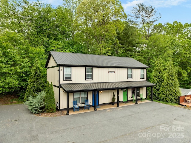 12 Martin Valley Rd, Swannanoa, NC 28778 - view of front of property featuring a porch, a standing seam roof, board and batten siding, metal roof, and asphalt driveway