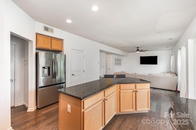 kitchen with a ceiling fan, stainless steel refrigerator with ice dispenser, visible vents, and dark wood finished floors
