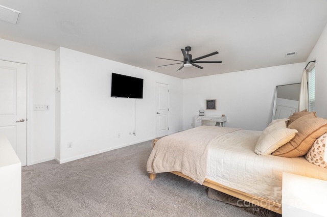 carpeted bedroom with visible vents, baseboards, and ceiling fan