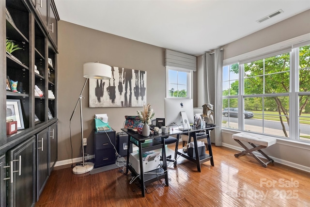 home office featuring baseboards and wood finished floors