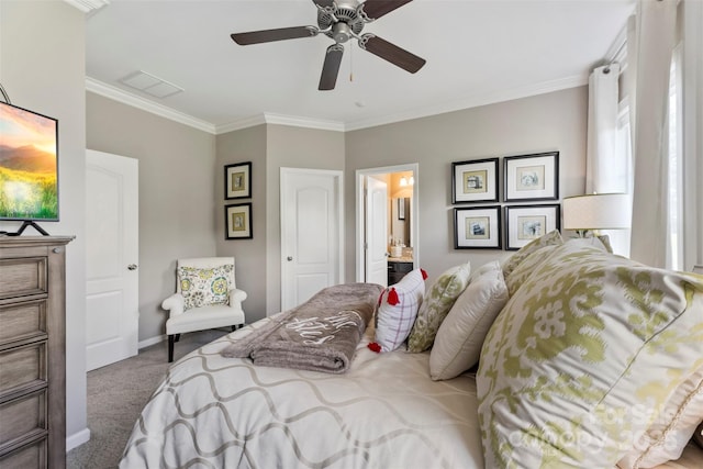 carpeted bedroom featuring crown molding, baseboards, a ceiling fan, and ensuite bathroom