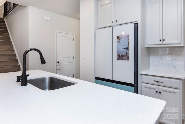 3252 Cheyney Park Dr, Charlotte, NC 28269 - kitchen featuring freestanding refrigerator, backsplash, light countertops, and a sink
