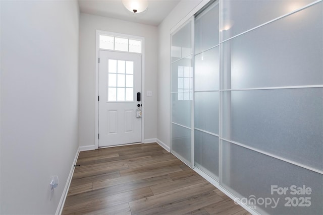 3252 Cheyney Park Dr, Charlotte, NC 28269 - doorway to outside featuring baseboards and wood finished floors