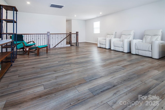 3252 Cheyney Park Dr, Charlotte, NC 28269 - sitting room with wood finished floors, visible vents, an upstairs landing, and recessed lighting