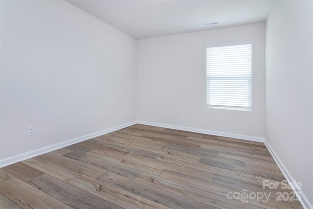3252 Cheyney Park Dr, Charlotte, NC 28269 - spare room with visible vents, wood finished floors, and baseboards