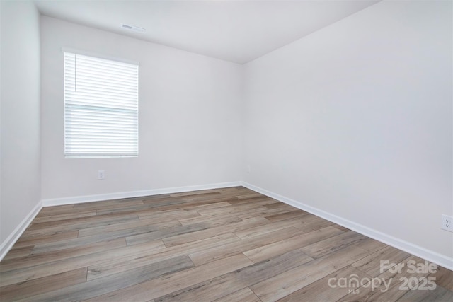 3252 Cheyney Park Dr, Charlotte, NC 28269 - unfurnished room with visible vents, wood finished floors, and baseboards