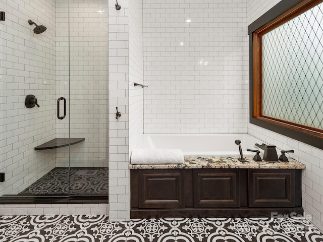 full bathroom featuring a shower stall and a bath