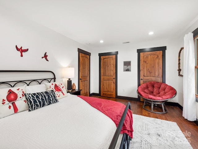 bedroom with wood finished floors, recessed lighting, and baseboards