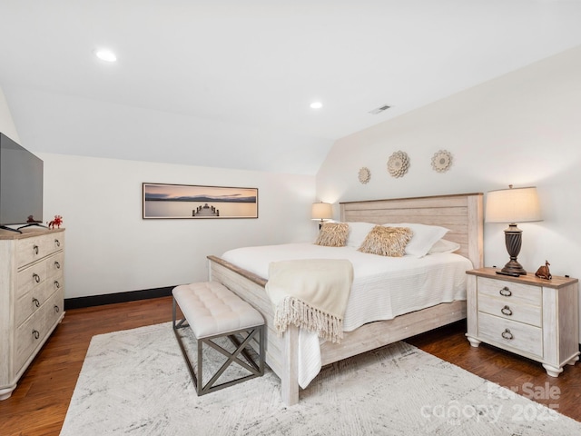 bedroom featuring vaulted ceiling, wood finished floors, baseboards, and recessed lighting