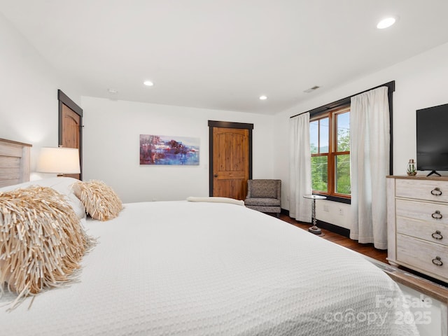 bedroom with dark wood-type flooring and recessed lighting