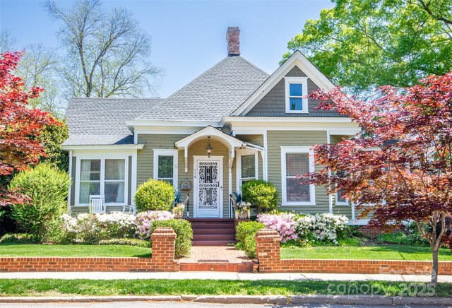 116 N Mulberry St, Statesville, NC 28677 - view of front of house featuring a shingled roof and a chimney