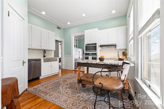 116 N Mulberry St, Statesville, NC 28677 - kitchen featuring appliances with stainless steel finishes, a sink, light countertops, white cabinetry, and wood finished floors