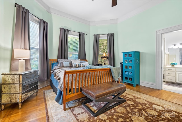 116 N Mulberry St, Statesville, NC 28677 - bedroom featuring light wood-style floors, connected bathroom, and a ceiling fan