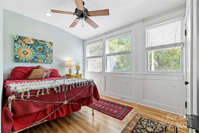 116 N Mulberry St, Statesville, NC 28677 - bedroom featuring wood finished floors, lofted ceiling, a ceiling fan, and a decorative wall