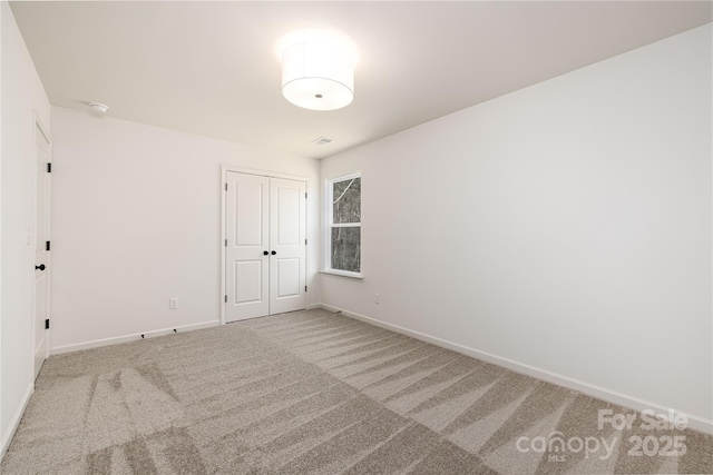 1604 Breezewood Dr, Charlotte, NC 28262 - unfurnished bedroom with baseboards, carpet, and a closet