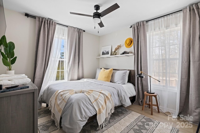 192 Duckworth Ave, Brevard, NC 28712 - bedroom with multiple windows, wood finished floors, and a ceiling fan