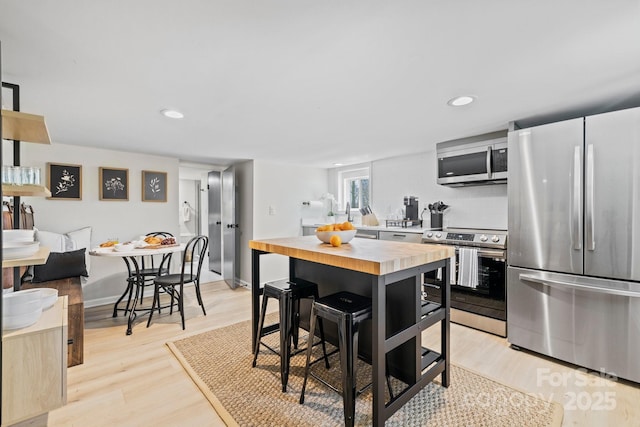 192 Duckworth Ave, Brevard, NC 28712 - kitchen with appliances with stainless steel finishes, wooden counters, light wood-style flooring, recessed lighting, and decorative backsplash