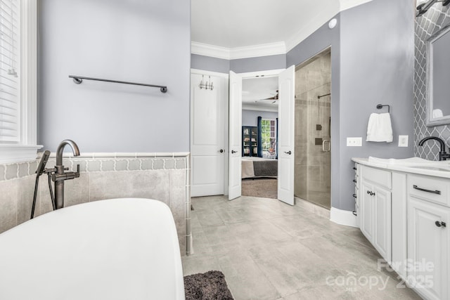 full bathroom featuring crown molding, vanity, tile walls, a soaking tub, and a shower stall