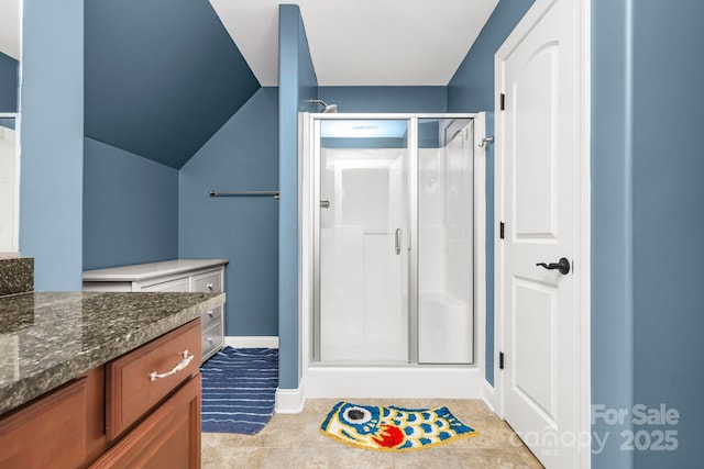 bathroom featuring vanity, baseboards, and a shower stall