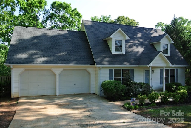 177 Line Dr, Forest City, NC 28043 - new england style home featuring driveway, a shingled roof, and a garage