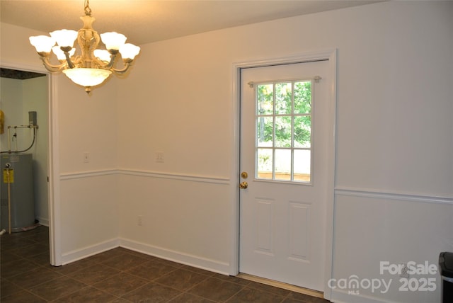 177 Line Dr, Forest City, NC 28043 - doorway featuring water heater, baseboards, dark tile patterned flooring, and a chandelier