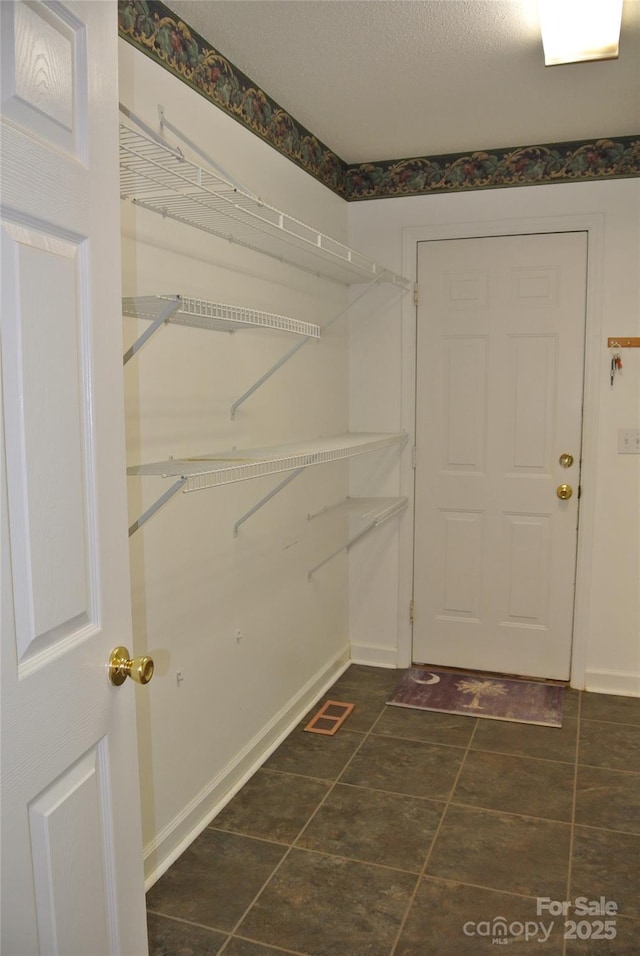 177 Line Dr, Forest City, NC 28043 - walk in closet featuring visible vents and dark tile patterned floors
