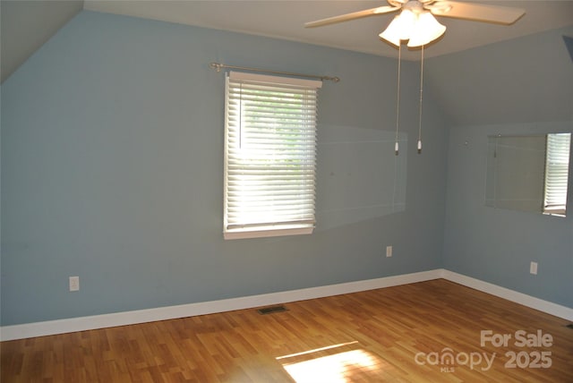 177 Line Dr, Forest City, NC 28043 - empty room with a ceiling fan, visible vents, vaulted ceiling, wood finished floors, and baseboards