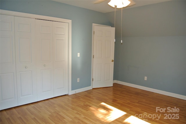 177 Line Dr, Forest City, NC 28043 - unfurnished bedroom featuring baseboards, ceiling fan, light wood finished floors, and a closet